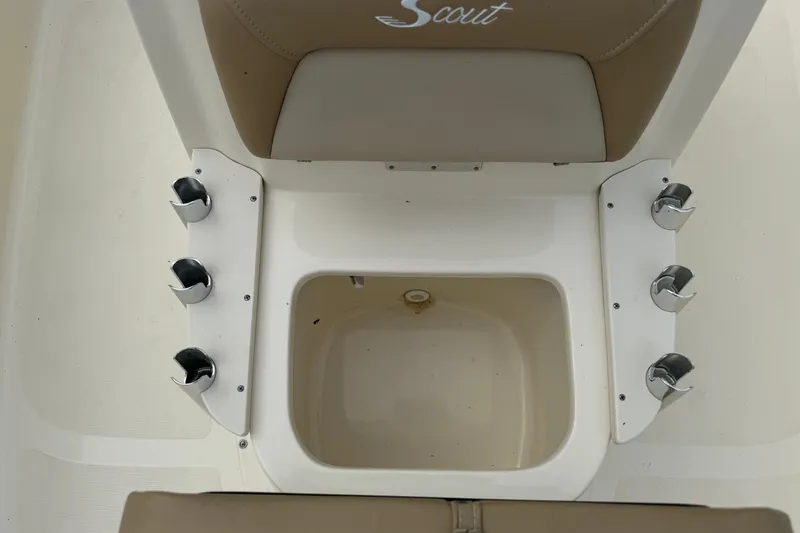 Slide: The Image of 2022 Scout 177 Sport boat interior with rod holders and storage compartment. - 10