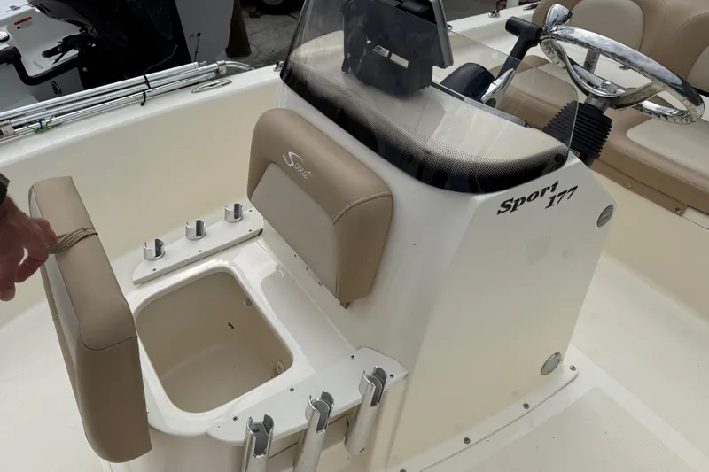 Slide: The Image of 2022 Scout 177 Sport boat interior with steering wheel and storage compartment. - 11