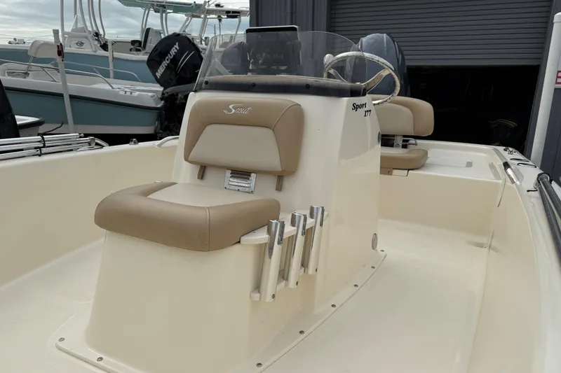 Slide: The Image of 2022 Scout 177 Sport boat interior with beige seating and steering console. - 7