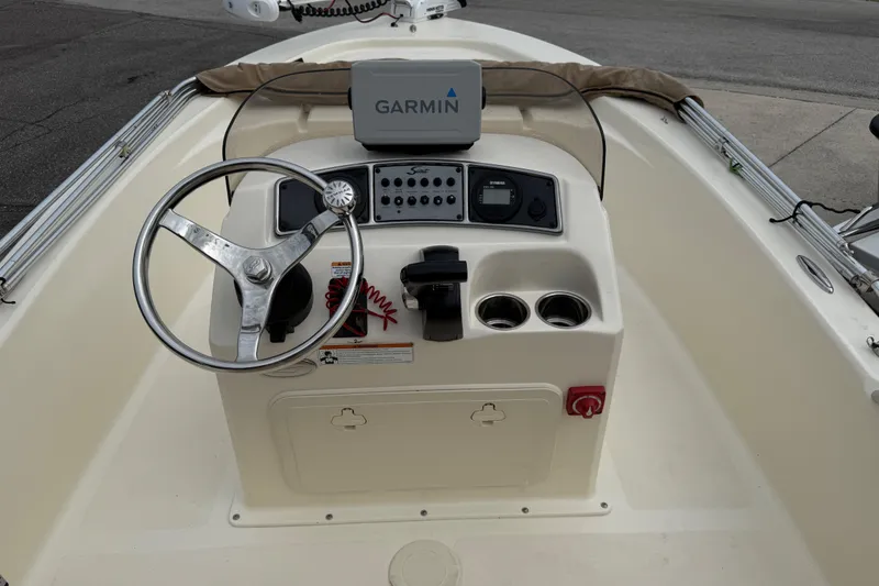 Slide: The Image of 2022 Scout 177 Sport boat dashboard with Garmin navigation system and steering wheel. - 9