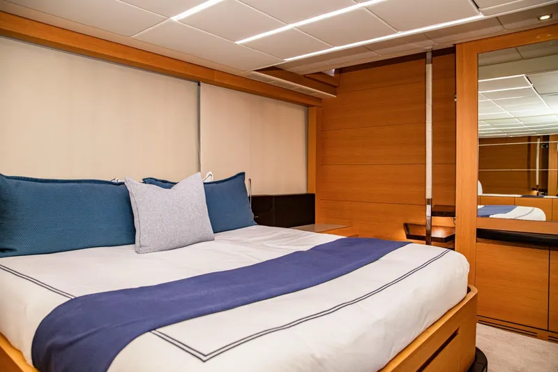Slide: The Image of Luxurious bedroom interior of 2012 Pershing Sport Boat Planning, featuring elegant wood paneling. - 12