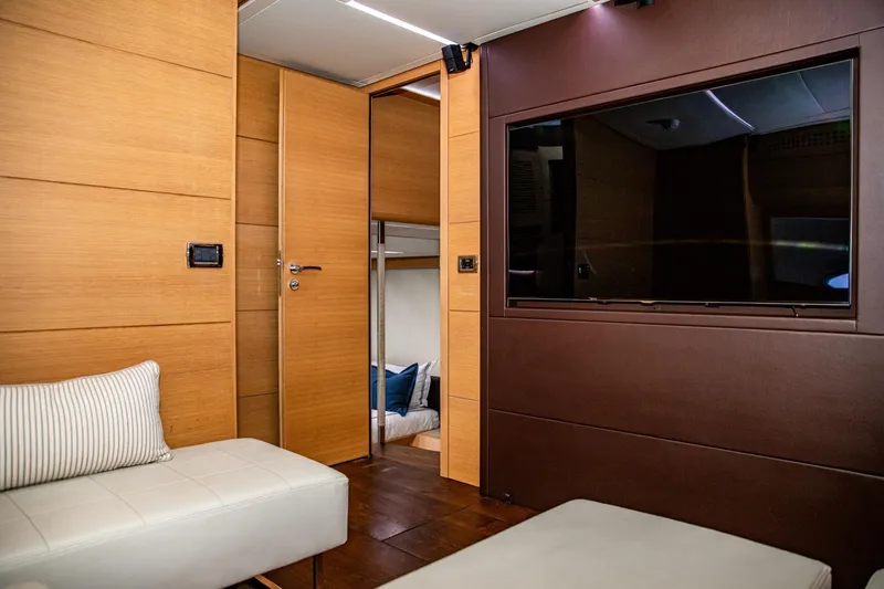 Slide: The Image of Luxurious interior of 2012 Pershing Sport Boat, featuring modern wood paneling and a large TV. - 15