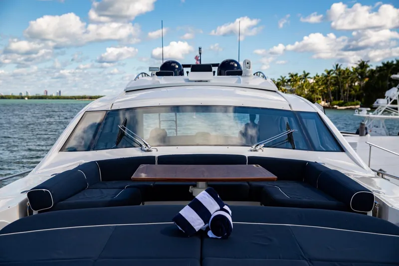 Slide: The Image of 2012 Pershing Sport Boat Planning on water, featuring luxurious deck seating and table. - 23