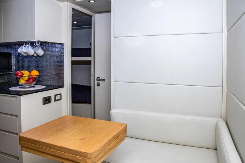 Slide: The Image of Interior of 2012 Pershing Sport Boat with modern kitchen and cozy seating area. - 11