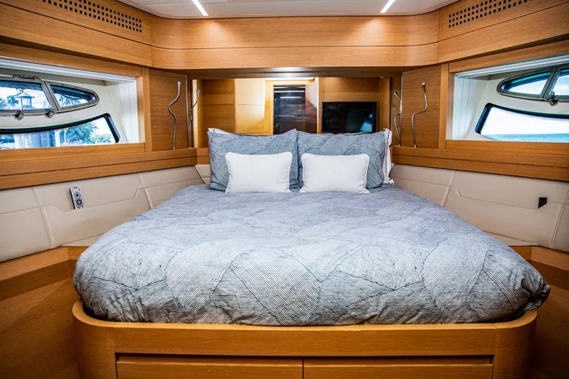 Slide: The Image of Luxurious bedroom interior of 2012 Pershing Sport Boat Planning, featuring elegant wood finishes. - 18
