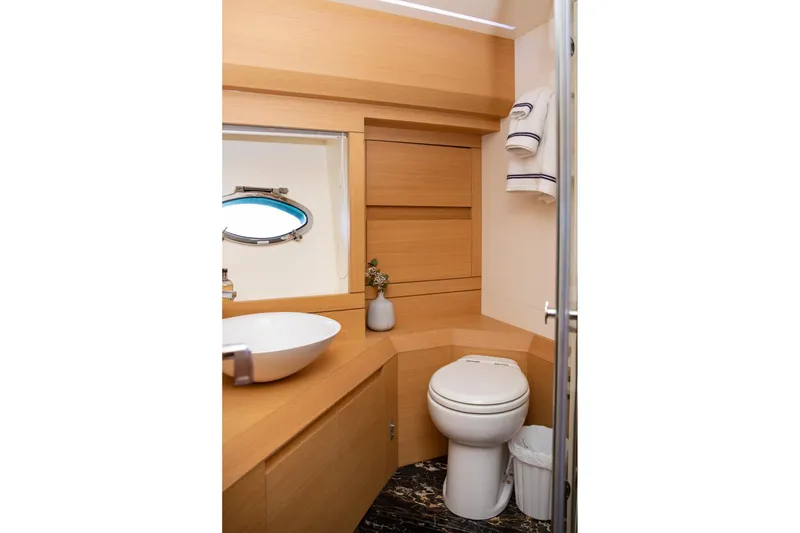 Slide: The Image of Luxurious bathroom in 2012 Pershing Sport Boat, featuring modern fixtures and elegant wood finishes. - 19