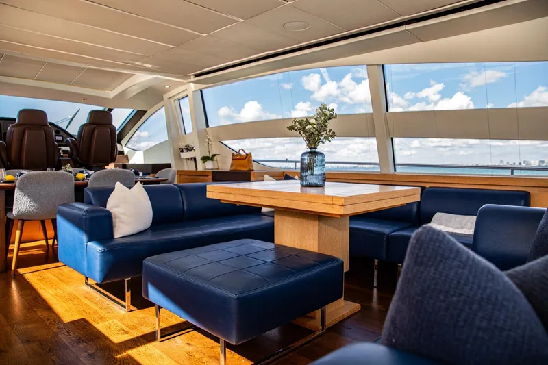 Slide: The Image of Luxurious interior of 2012 Pershing Sport Boat with blue seating and wooden table. - 5
