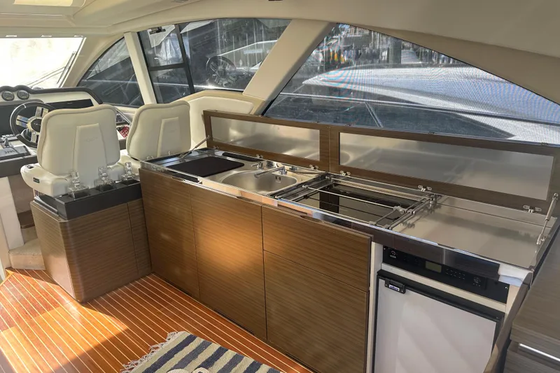 Slide: The Image of Interior of 2015 Azimut 55S yacht featuring modern kitchen and helm station. - 11