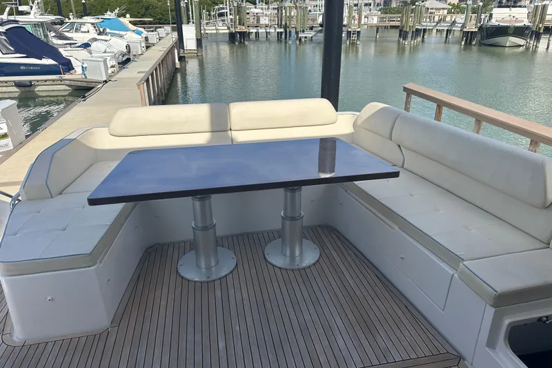 Slide: The Image of Luxury seating area on 2015 Azimut 55S yacht with wooden table and marina view. - 3