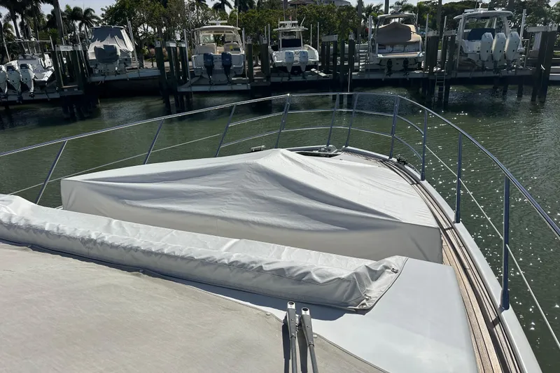 Slide: The Image of 2015 Azimut 55S yacht bow view at marina with covered deck. - 30