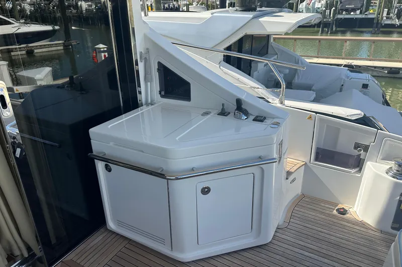 Slide: The Image of 2015 Azimut 55S yacht deck with sleek white cabinetry and modern design. - 5