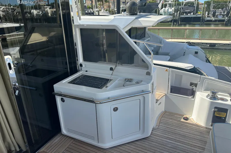 Slide: The Image of 2015 Azimut 55S yacht with outdoor kitchen and sleek design at marina. - 6