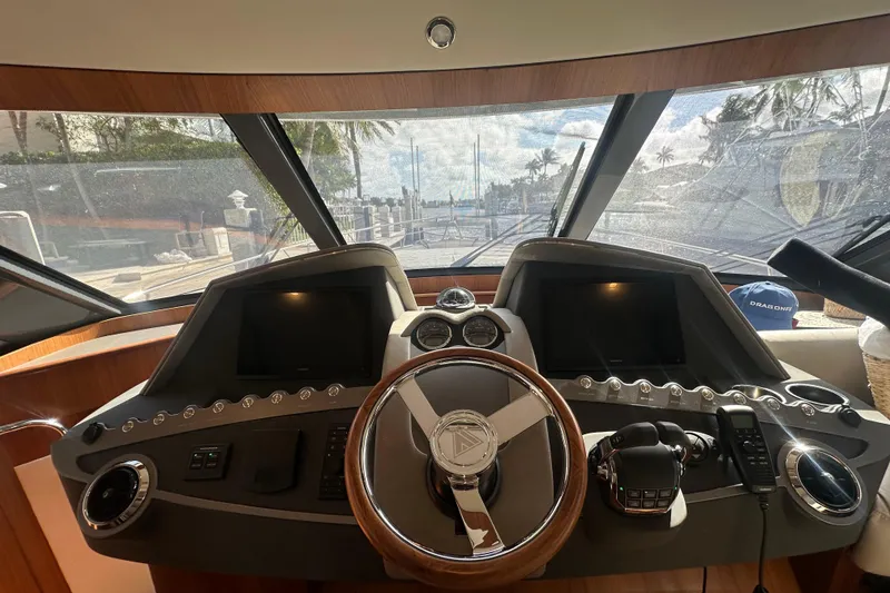 Slide: The Image of Interior view of 2023 Belize 54 Day Bridge yacht helm with steering wheel and control panels. - 16