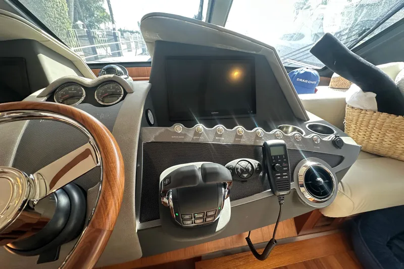 Slide: The Image of Control panel of 2023 Belize 54 Day Bridge yacht with steering wheel and navigation instruments. - 18