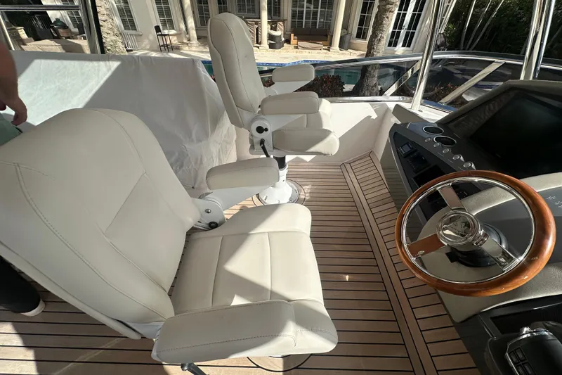Slide: The Image of Luxury yacht helm with white leather seats, wooden steering wheel, Belize 54 Day Bridge 2023. - 28