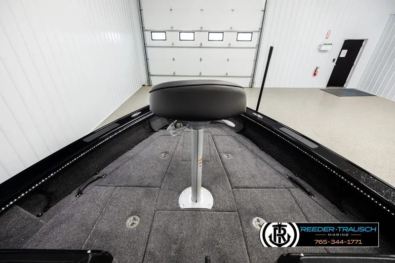 Slide: The Image of 2026 Lund 1975 Pro-V Sport boat interior with gray carpet and swivel seat. - 14