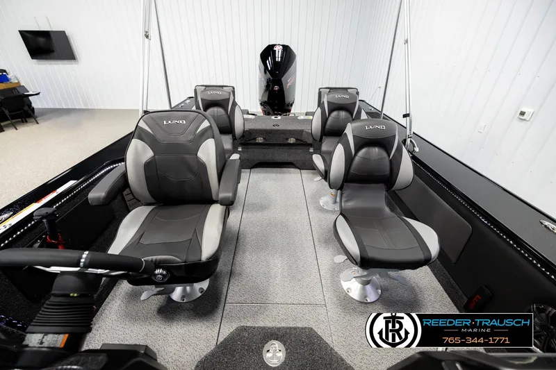 Slide: The Image of 2026 Lund 1975 Pro-V Sport boat interior with four gray seats in a showroom. - 16