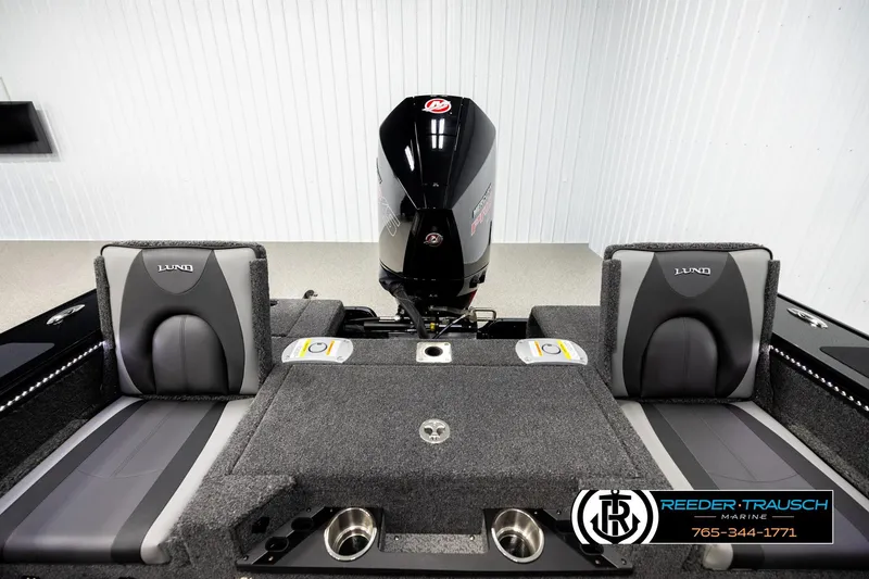 Slide: The Image of 2026 Lund 1975 Pro-V Sport boat interior with seating and motor, Reeder-Trausch Marine branding. - 17