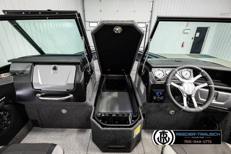 Slide: The Image of 2026 Lund 1975 Pro-V Sport boat interior with open storage compartment and steering wheel. - 21