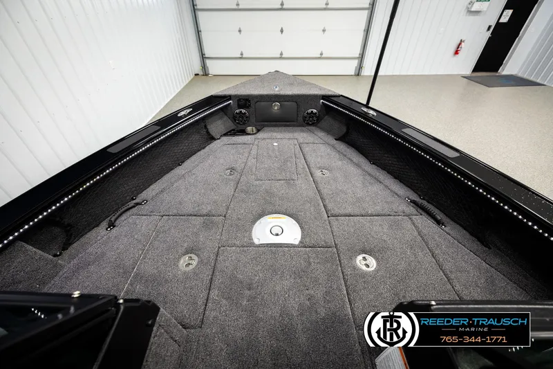 Slide: The Image of 2026 Lund 1975 Pro-V Sport boat interior with carpeted deck and storage compartments. - 22