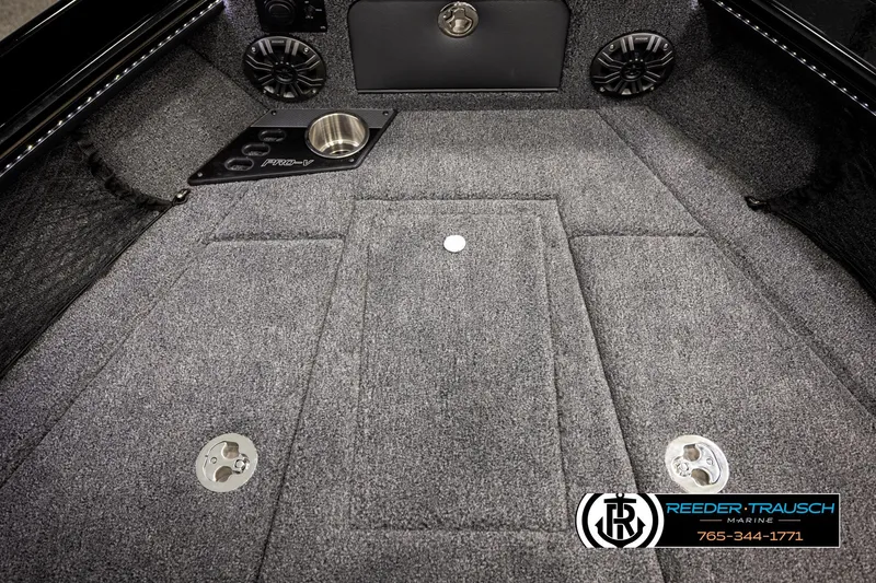Slide: The Image of 2026 Lund 1975 Pro-V Sport boat interior with carpeted flooring and speaker system. - 24