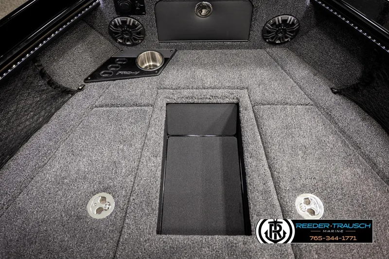 Slide: The Image of Interior of 2026 Lund 1975 Pro-V Sport boat with carpeted flooring and speaker system. - 25