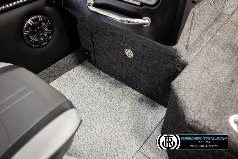 Slide: The Image of Interior of 2026 Lund 1975 Pro-V Sport boat with speaker and carpeted flooring. - 32