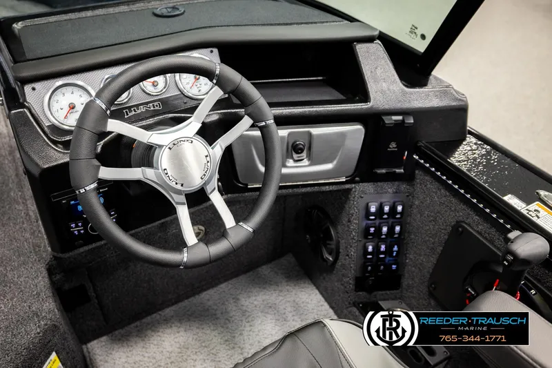 Slide: The Image of Interior of 2026 Lund 1975 Pro-V Sport boat with steering wheel and control panel. - 37