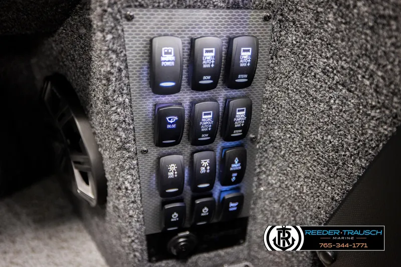Slide: The Image of Control panel of 2026 Lund 1975 Pro-V Sport boat with various switches. - 43