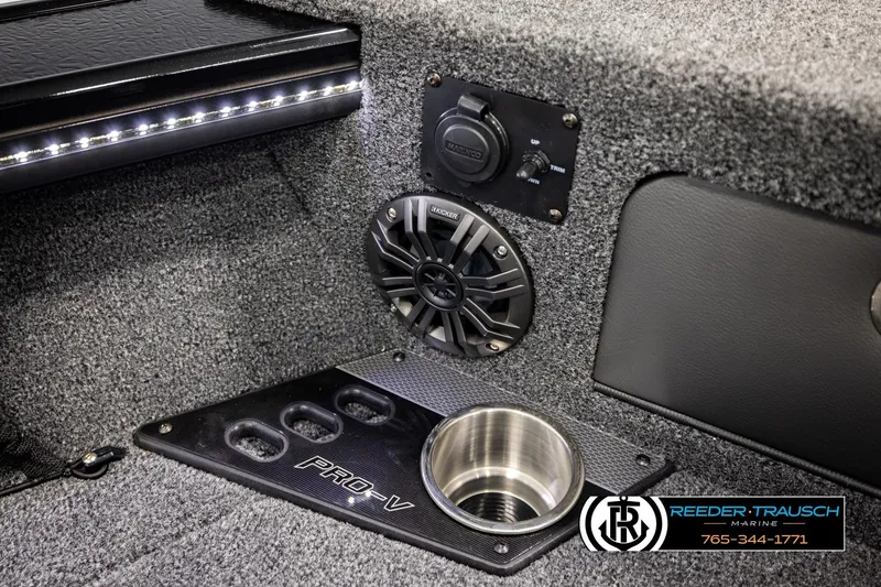 Slide: The Image of 2026 Lund 1975 Pro-V Sport boat interior with speaker and cup holder. - 49