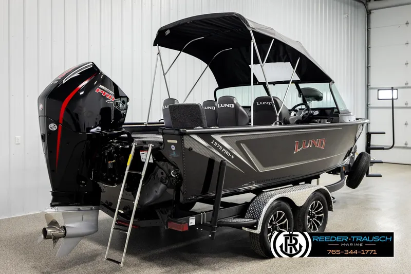 Slide: The Image of 2026 Lund 1975 Pro-V Sport boat with Mercury engine in showroom. - 5