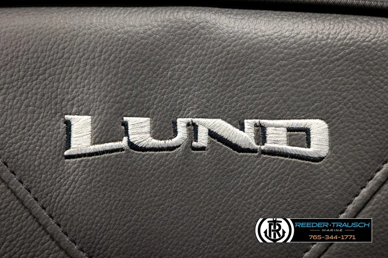 Slide: The Image of Lund 1975 Pro-V Sport 2026 logo on gray leather upholstery, Reeder-Trausch Marine branding. - 52
