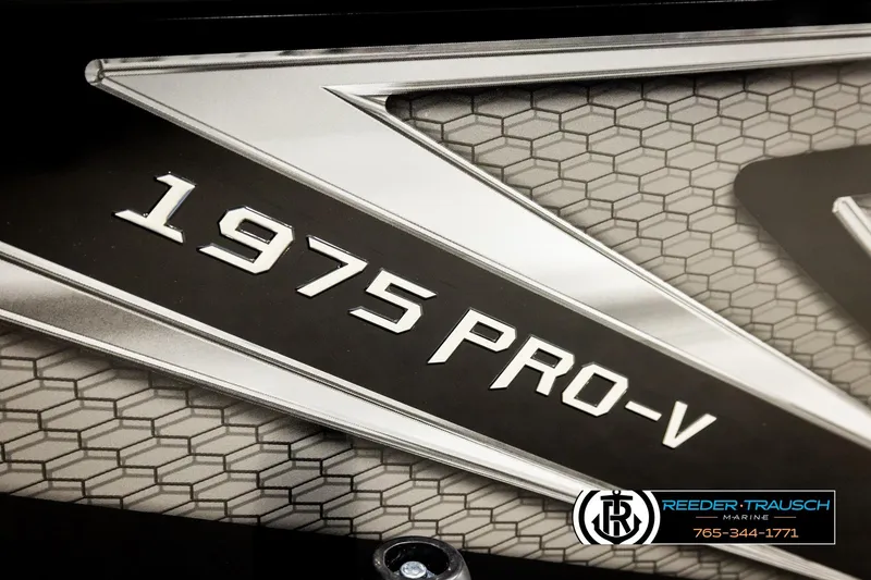 Slide: The Image of Close-up of Lund 1975 Pro-V Sport 2026 model emblem with hexagonal pattern background. - 60