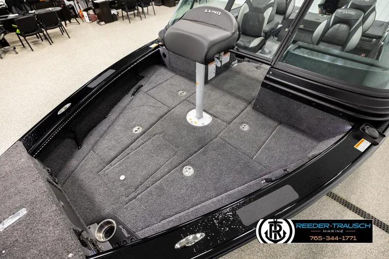 Slide: The Image of 2026 Lund 1975 Pro-V Sport boat interior with seating and carpeted deck. - 9