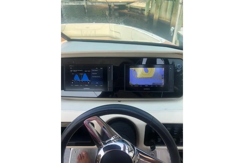 Slide: The Image of 2019 Regal LS6 boat dashboard with Garmin navigation displays and steering wheel. - 4