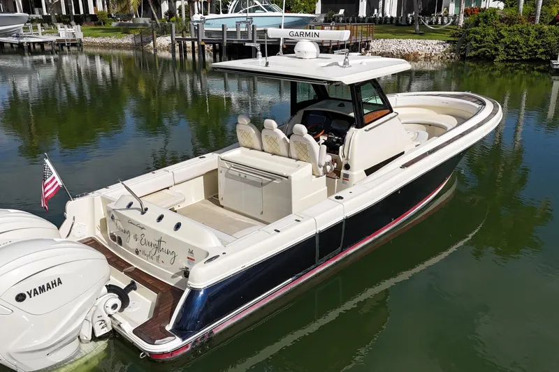 Slide: The Image of 2020 Chris-Craft Catalina 34 boat with Yamaha engines docked in a serene marina. - 10