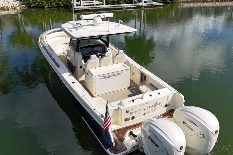 Slide: The Image of 2020 Chris-Craft Catalina 34 boat with dual Yamaha engines on a calm lake. - 11