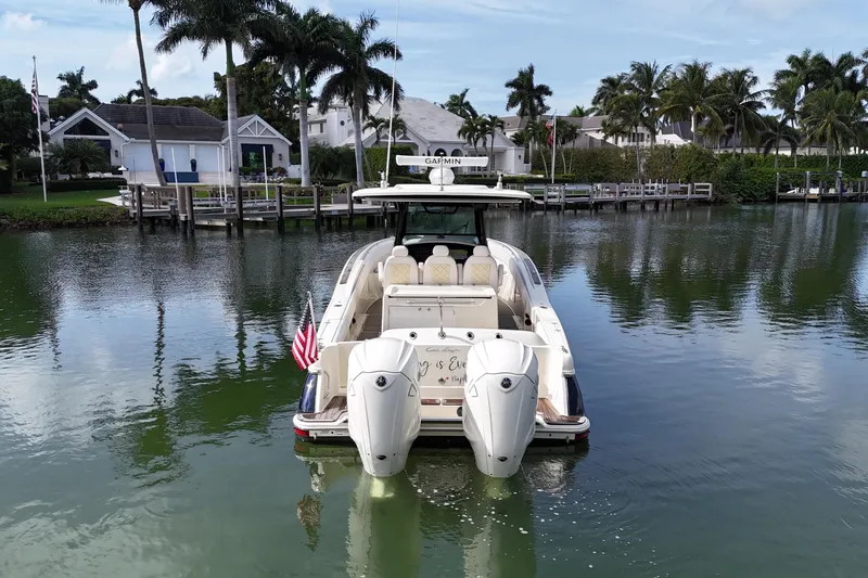Slide: The Image of 2020 Chris-Craft Catalina 34 boat docked in a scenic waterfront setting. - 12