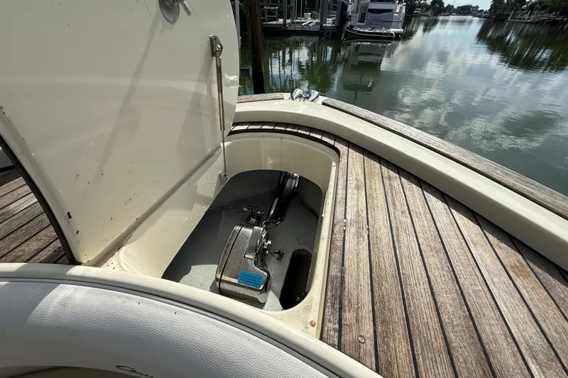 Slide: The Image of 2020 Chris-Craft Catalina 34 anchor compartment with open hatch, docked by calm waters. - 20