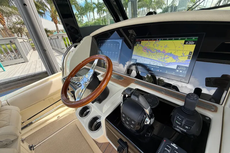 Slide: The Image of 2020 Chris-Craft Catalina 34 helm with navigation display and wooden steering wheel. - 22