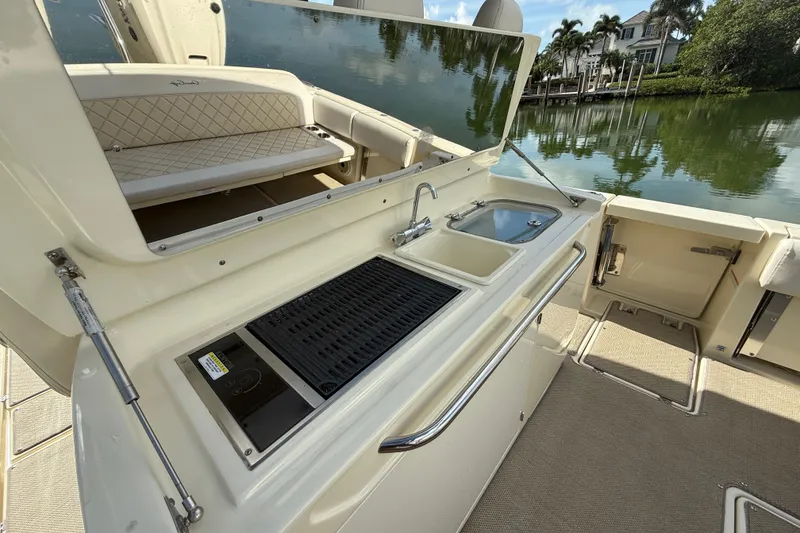 Slide: The Image of 2020 Chris-Craft Catalina 34 boat with outdoor kitchen and scenic waterfront view. - 23