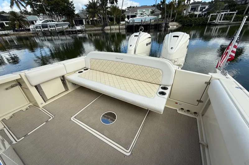 Slide: The Image of 2020 Chris-Craft Catalina 34 boat interior with cushioned seating and twin outboard engines. - 24