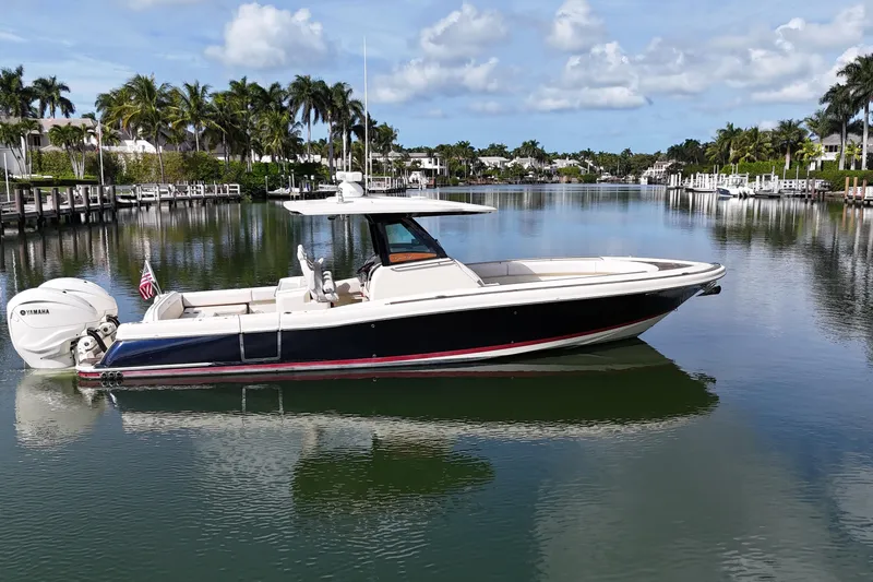 Slide: The Image of 2020 Chris-Craft Catalina 34 boat on a calm, scenic waterway with palm trees. - 3