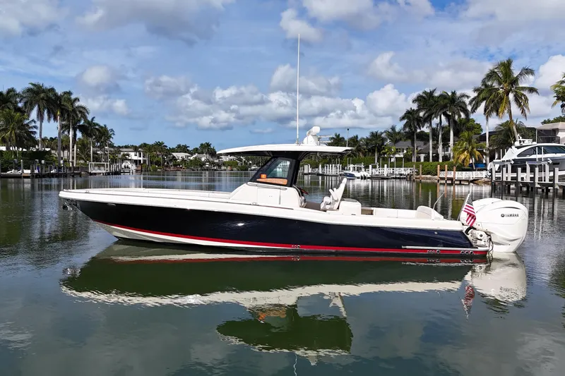 Slide: The Image of 2020 Chris-Craft Catalina 34 boat on calm water with palm trees in the background. - 7