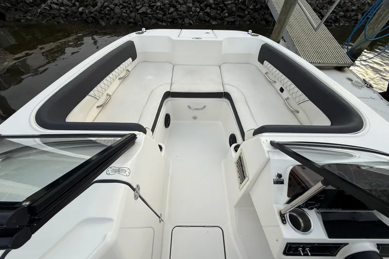 Slide: The Image of 2023 Bayliner DX 2200 boat interior with spacious seating and modern design. - 10