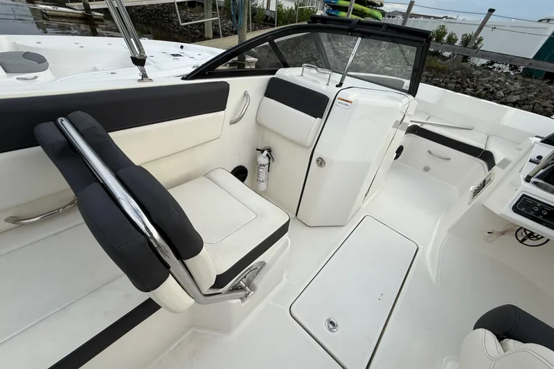 Slide: The Image of 2023 Bayliner DX 2200 boat interior with seating and storage compartments. - 5