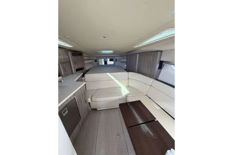 Slide: The Image of 2019 Regal 3350 Sport Cruiser interior with modern seating and cabinetry. - 10