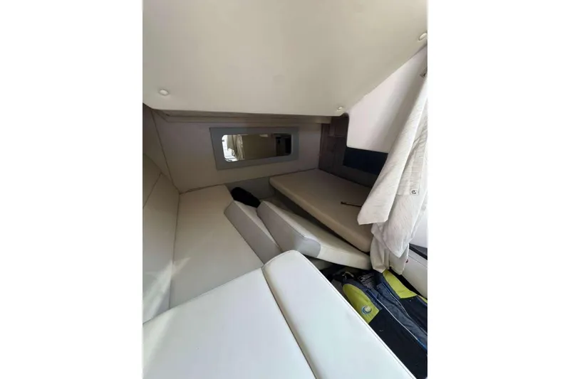 Slide: The Image of Interior cabin of 2019 Regal 3350 Sport Cruiser with white seating and window. - 11