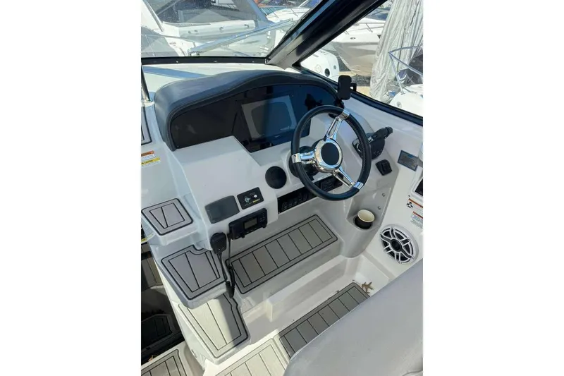 Slide: The Image of 2019 Regal 3350 Sport Cruiser helm with steering wheel and control panel. - 14