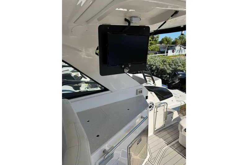 Slide: The Image of 2019 Regal 3350 Sport Cruiser interior with TV and seating area. - 3